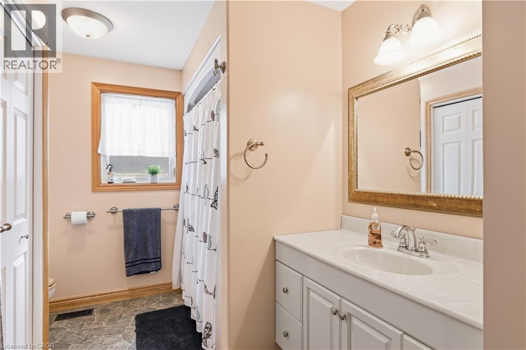 Bathroom with vanity, a shower with shower curtain, and stone finish floors - 230 Saugeen Street, Grey Highlands, ON - Indoor Photo Showing Bathroom