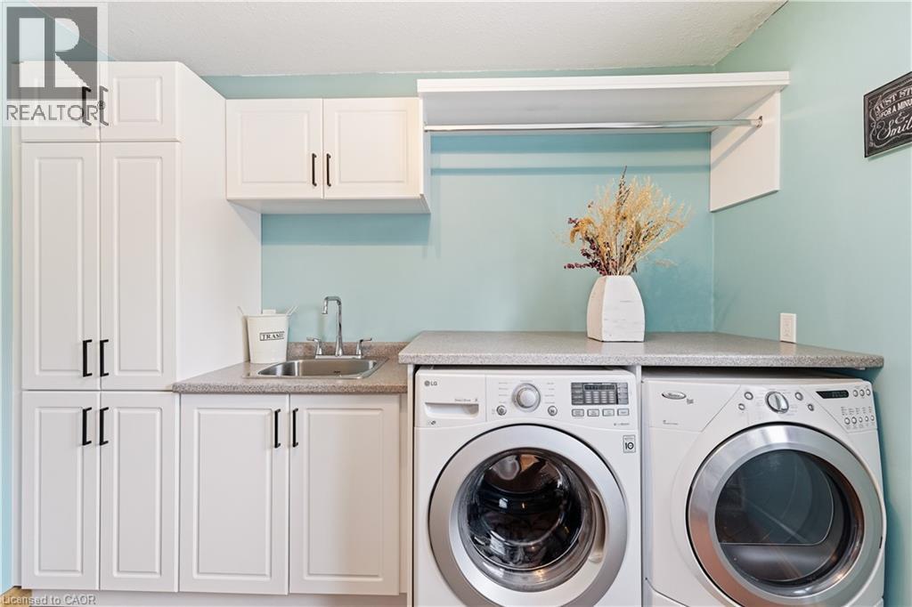 Laundry area featuring washing machine and clothes dryer and cabinet space - 230 Saugeen Street, Grey Highlands, ON - Indoor Photo Showing Laundry Room