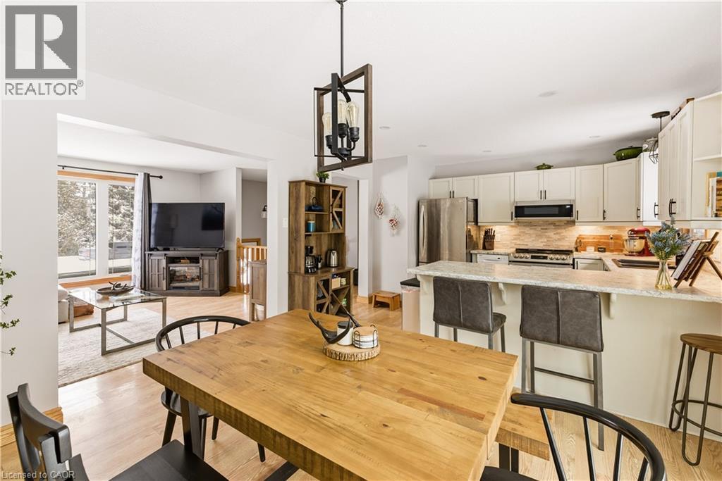 Dining room with light wood-type flooring and a fireplace - 230 Saugeen Street, Grey Highlands, ON - Indoor