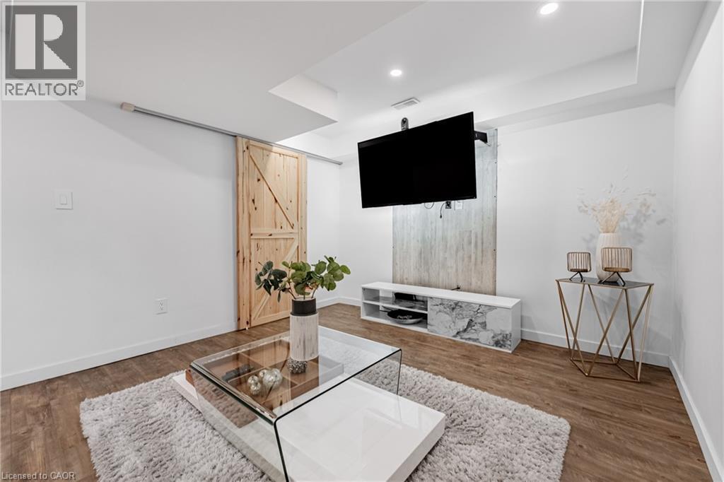 Bar area with light wood-style flooring and recessed lighting - 5056 New Street Unit# 21, Burlington, ON - Indoor
