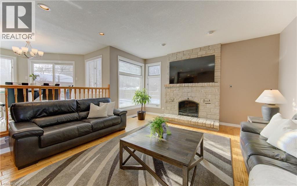 Family room with wood fireplace - 593 Guildwood Place, Waterloo, ON - Indoor Photo Showing Living Room With Fireplace