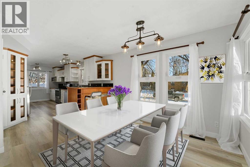 The dining area is also surrounded by windows, creating a bright and inviting space - 4 Pardue Close, Red Deer, AB - Indoor Photo Showing Dining Room