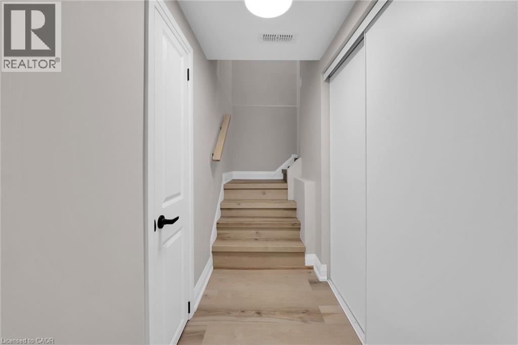 Staircase featuring wood finished floors - 174 East 34Th Street, Hamilton, ON - Indoor Photo Showing Other Room