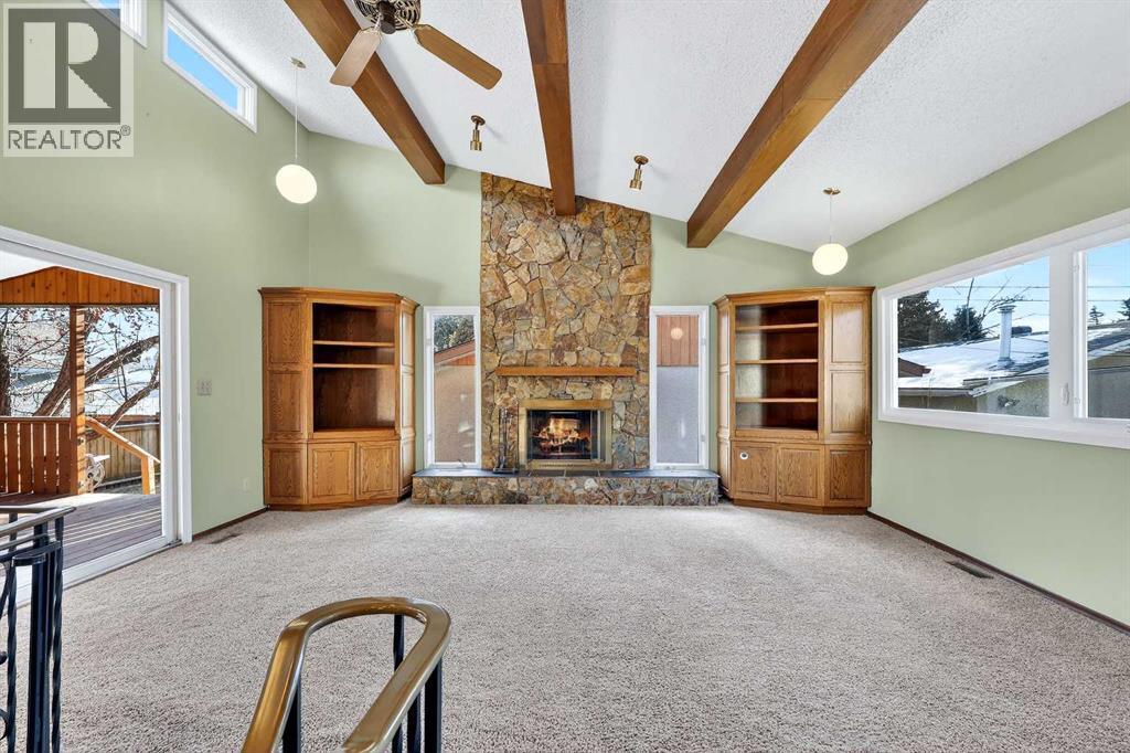 Family Room - Vaulted Open Beam 19'3" x 16'8" - 5315 Valiant Drive Nw, Calgary, AB - Indoor With Fireplace