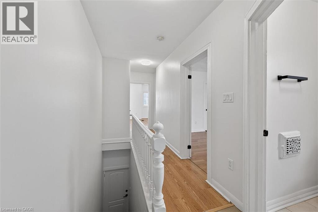 Corridor featuring an upstairs landing, light wood finished floors, and heating unit - 77 Barton Street E Unit# 2, Hamilton, ON - Indoor Photo Showing Other Room