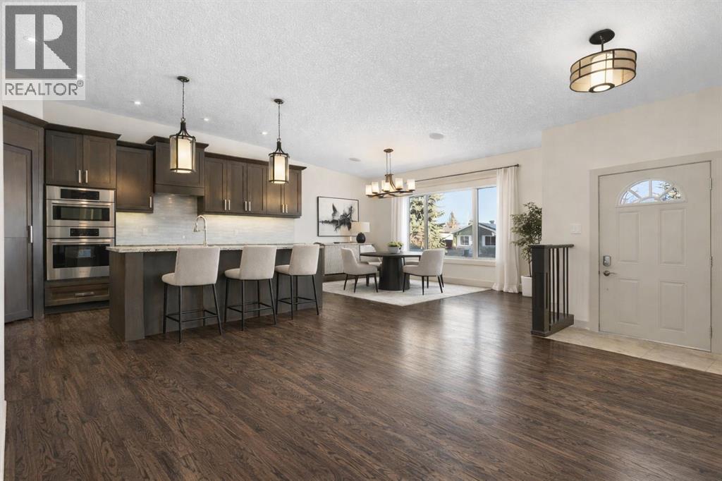 This photo has been virtually staged - 4711 Norquay Drive Nw, Calgary, AB - Indoor Photo Showing Kitchen With Stainless Steel Kitchen With Upgraded Kitchen