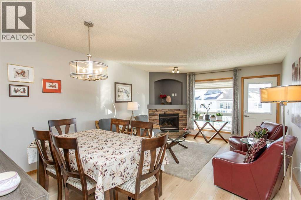 409 Jenkins Drive, Red Deer, AB - Indoor Photo Showing Dining Room With Fireplace