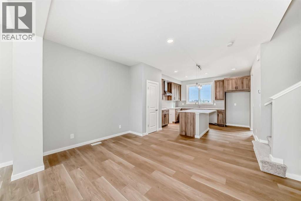 PLEASE NOTE: Photos are of a DIFFERENT Spec Home of the same model – fit and finish may differ. Interior selections and floorplans shown in photos - 85 Starling Boulevard Nw, Calgary, AB - Indoor Photo Showing Kitchen