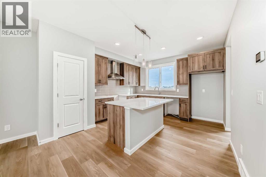 PLEASE NOTE: Photos are of a DIFFERENT Spec Home of the same model – fit and finish may differ. Interior selections and floorplans shown in photos - 85 Starling Boulevard Nw, Calgary, AB - Indoor Photo Showing Kitchen