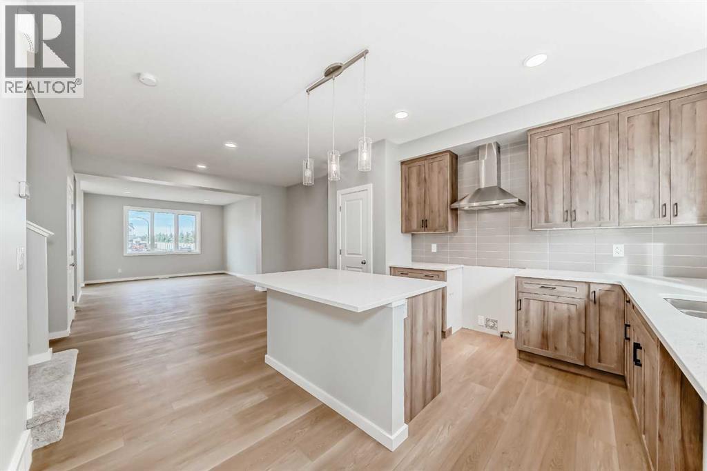 PLEASE NOTE: Photos are of a DIFFERENT Spec Home of the same model – fit and finish may differ. Interior selections and floorplans shown in photos - 85 Starling Boulevard Nw, Calgary, AB - Indoor Photo Showing Kitchen With Upgraded Kitchen