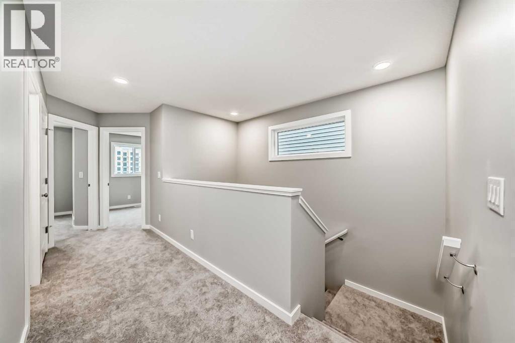PLEASE NOTE: Photos are of a DIFFERENT Spec Home of the same model – fit and finish may differ. Interior selections and floorplans shown in photos - 85 Starling Boulevard Nw, Calgary, AB - Indoor Photo Showing Other Room