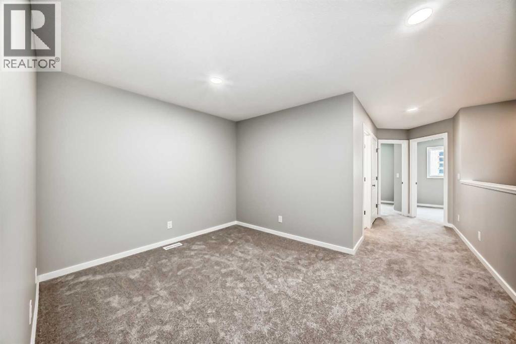 PLEASE NOTE: Photos are of a DIFFERENT Spec Home of the same model – fit and finish may differ. Interior selections and floorplans shown in photos - 85 Starling Boulevard Nw, Calgary, AB - Indoor Photo Showing Other Room