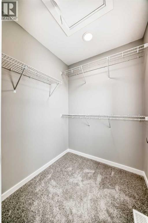 PLEASE NOTE: Photos are of a DIFFERENT Spec Home of the same model – fit and finish may differ. Interior selections and floorplans shown in photos - 85 Starling Boulevard Nw, Calgary, AB - Indoor With Storage