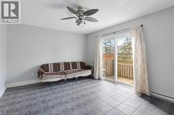 Sitting room with ceiling fan and a baseboard heating unit -