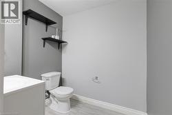 Bathroom in basement,tile patterned flooring, and toilet -