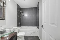 Bathroom with shower / washtub combination, tile patterned flooring, vanity, and toilet -