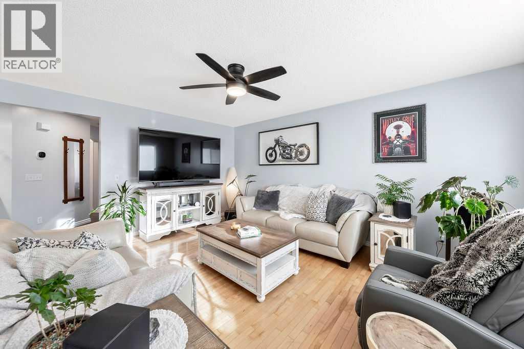A light-filled living room offering generous space for relaxation - 361 Cimarron Boulevard, Okotoks, AB - Indoor Photo Showing Living Room