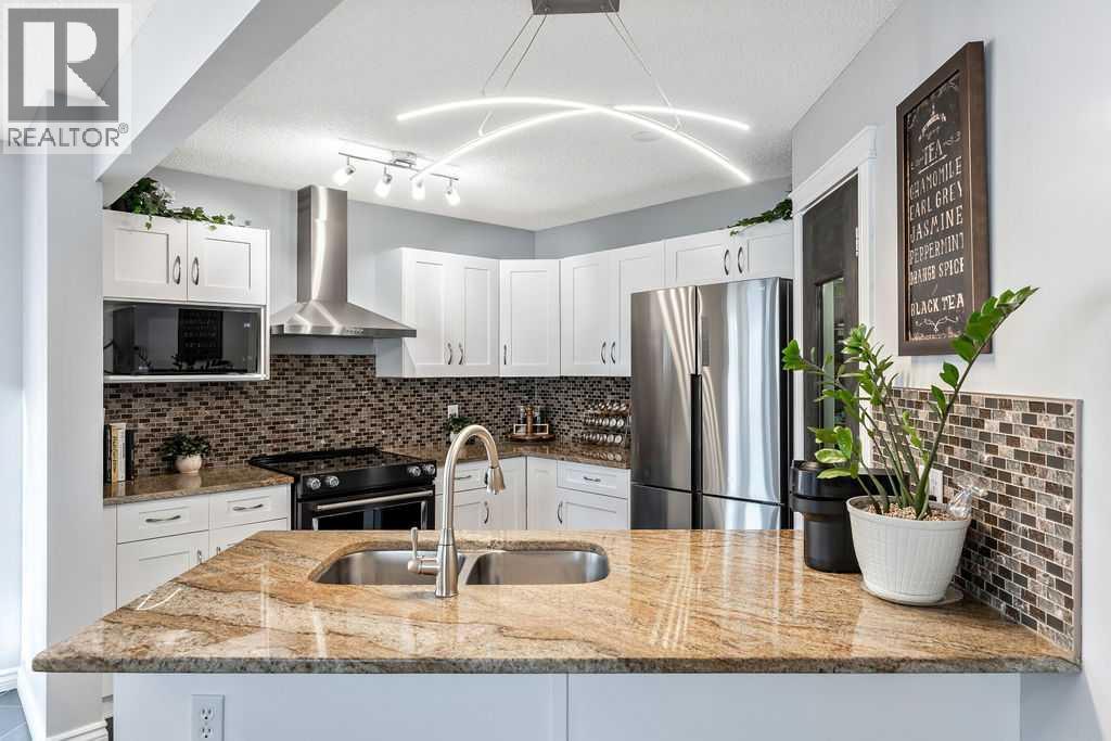 Modernized kitchen with timeless finishes - 361 Cimarron Boulevard, Okotoks, AB - Indoor Photo Showing Kitchen With Stainless Steel Kitchen With Double Sink With Upgraded Kitchen