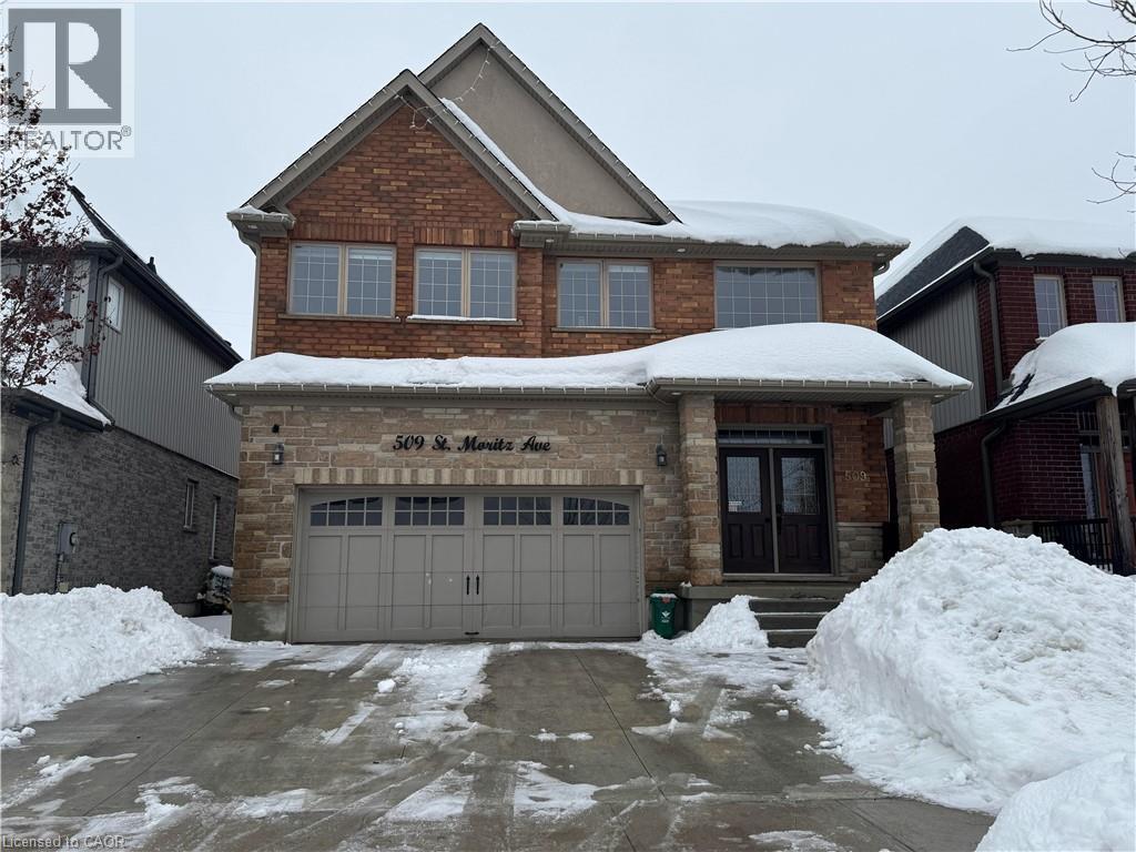 Craftsman-style home with an attached garage, driveway, stone siding, and french doors - 509 St Moritz Avenue Unit# Lower, Waterloo, ON - Outdoor