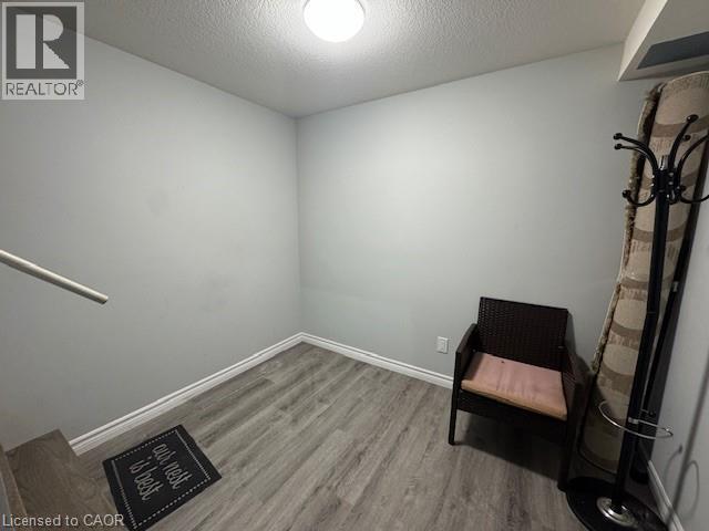 Unfurnished room with a textured ceiling and wood finished floors - 509 St Moritz Avenue Unit# Lower, Waterloo, ON - Indoor Photo Showing Other Room