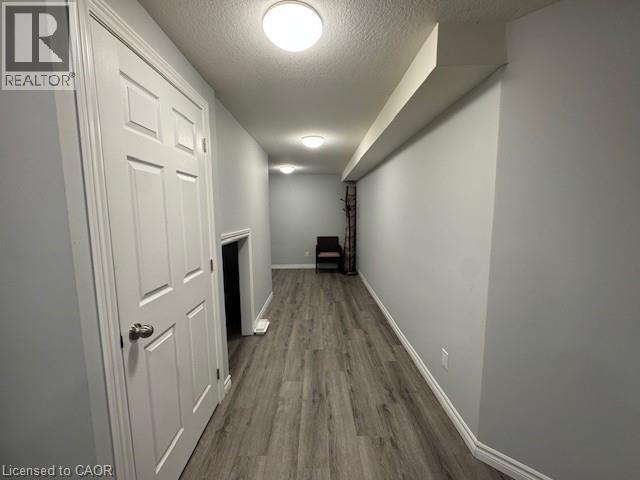 Hall with a textured ceiling and dark wood finished floors - 509 St Moritz Avenue Unit# Lower, Waterloo, ON - Indoor Photo Showing Other Room