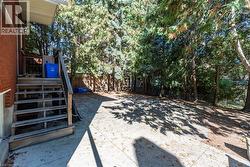 Fenced backyard featuring stairway -