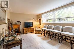 Living room featuring a fireplace and light tile patterned flooring -