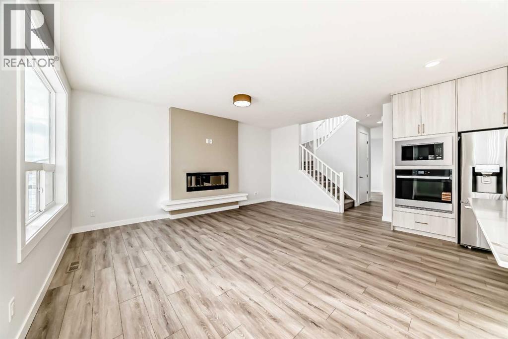 100 Corner Glen Manor Ne, Calgary, AB - Indoor With Fireplace