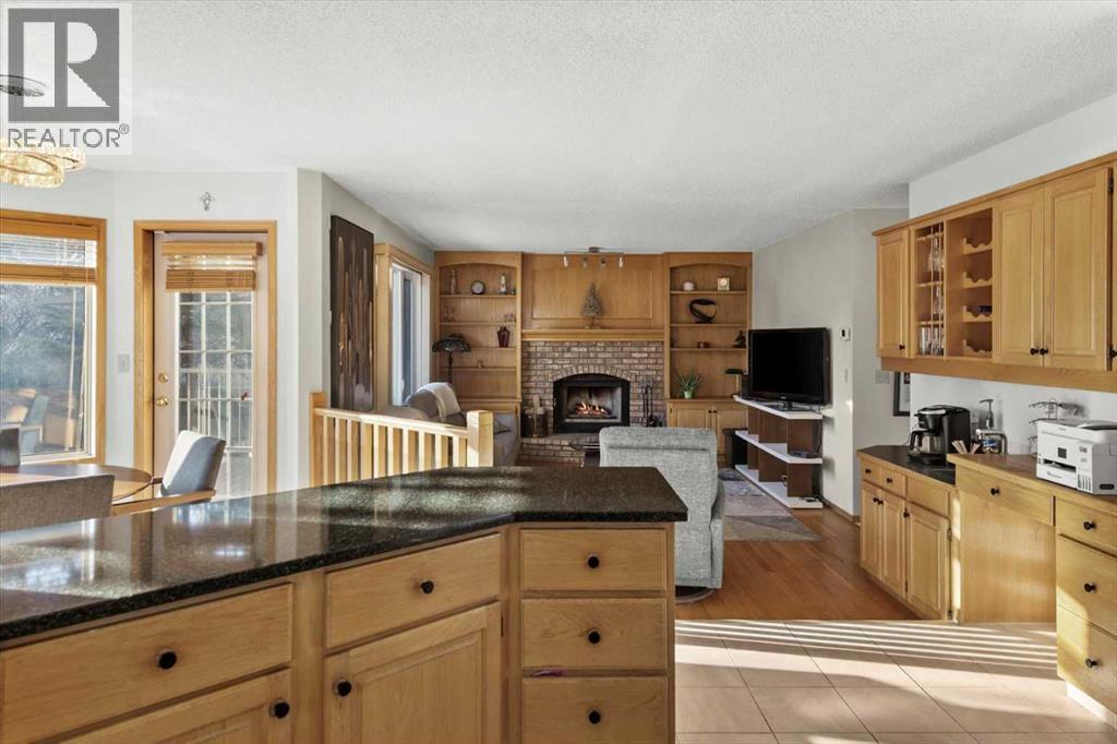 332 Hawkstone Close Nw, Calgary, AB - Indoor Photo Showing Kitchen With Fireplace