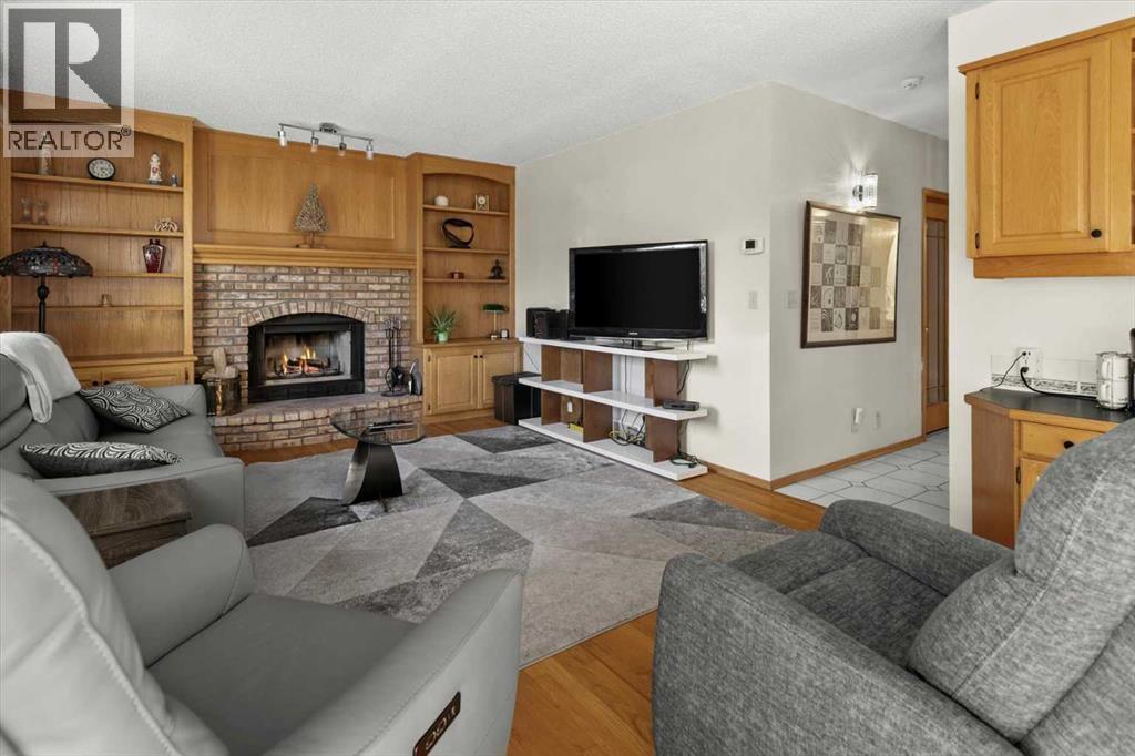 332 Hawkstone Close Nw, Calgary, AB - Indoor Photo Showing Living Room With Fireplace