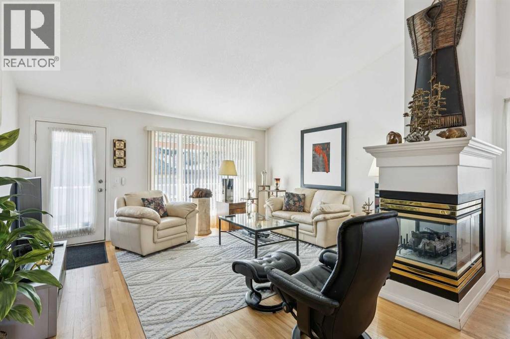 312 Prominence Heights Sw, Calgary, AB - Indoor Photo Showing Living Room With Fireplace