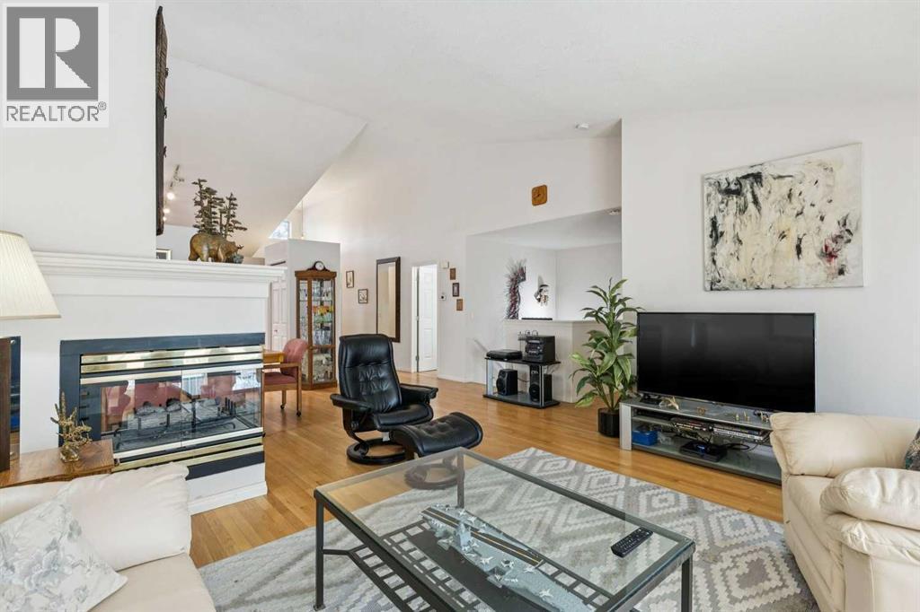 312 Prominence Heights Sw, Calgary, AB - Indoor Photo Showing Living Room With Fireplace