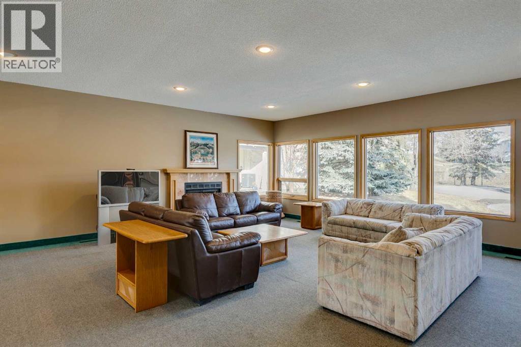 312 Prominence Heights Sw, Calgary, AB - Indoor Photo Showing Living Room With Fireplace