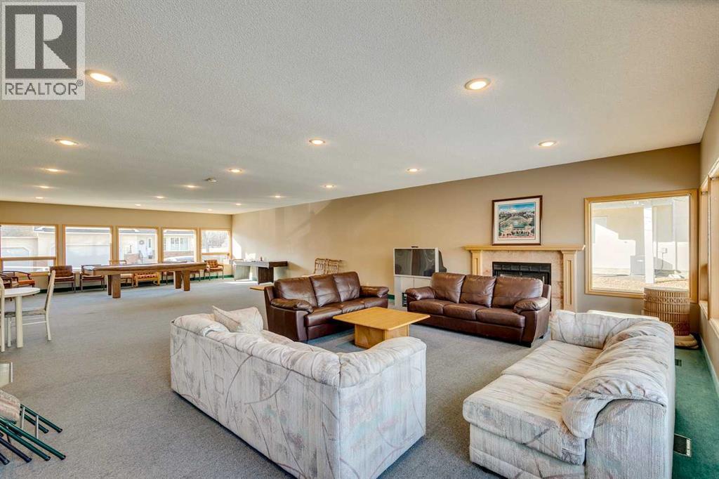 312 Prominence Heights Sw, Calgary, AB - Indoor Photo Showing Living Room With Fireplace