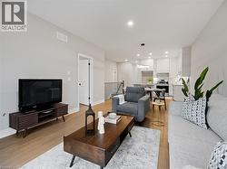 Living area with visible vents, recessed lighting, light wood-style floors, and baseboards -