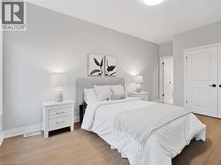 Bedroom featuring visible vents, light wood-style floors, and baseboards -