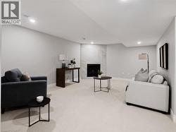 Living room featuring recessed lighting, carpet flooring, baseboards, and a fireplace -
