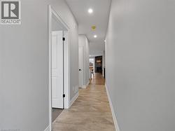 Hall with baseboards, recessed lighting, marble finish floor, and visible vents -