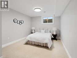 Carpeted bedroom with baseboards -