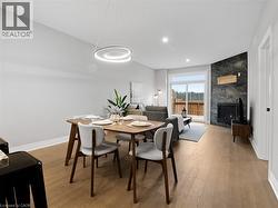 Dining area featuring baseboards, recessed lighting, light wood finished floors, and a tile fireplace -