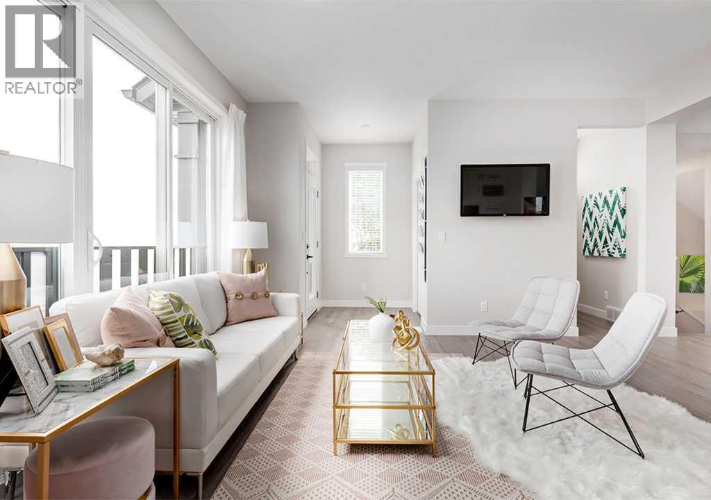 PLEASE NOTE: Photos are of a Showhome of the same model – fit & finish may differ. Interior selections & floorplans shown in photos - 162 Lanark Gate Se, Airdrie, AB - Indoor Photo Showing Living Room