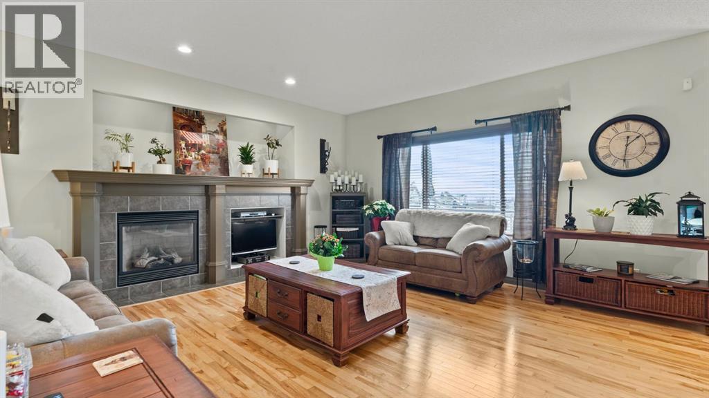 189 Rockyspring Terrace Nw, Calgary, AB - Indoor Photo Showing Living Room With Fireplace