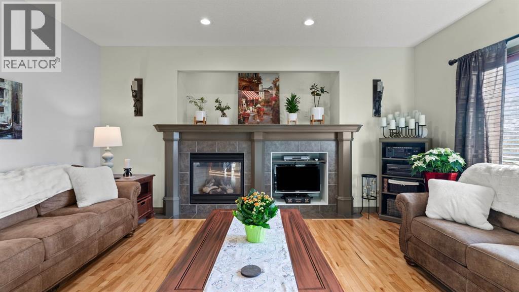 189 Rockyspring Terrace Nw, Calgary, AB - Indoor Photo Showing Living Room With Fireplace
