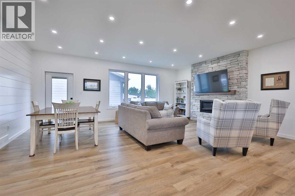 246 4A Street, Stirling, AB - Indoor Photo Showing Living Room With Fireplace