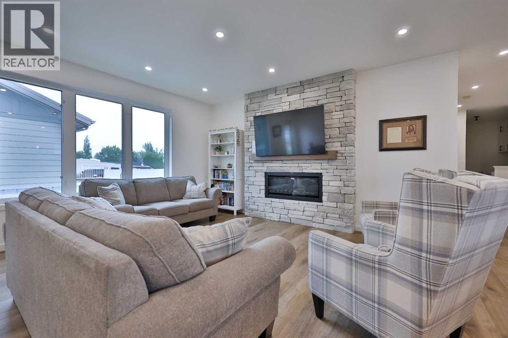 246 4A Street, Stirling, AB - Indoor Photo Showing Living Room With Fireplace
