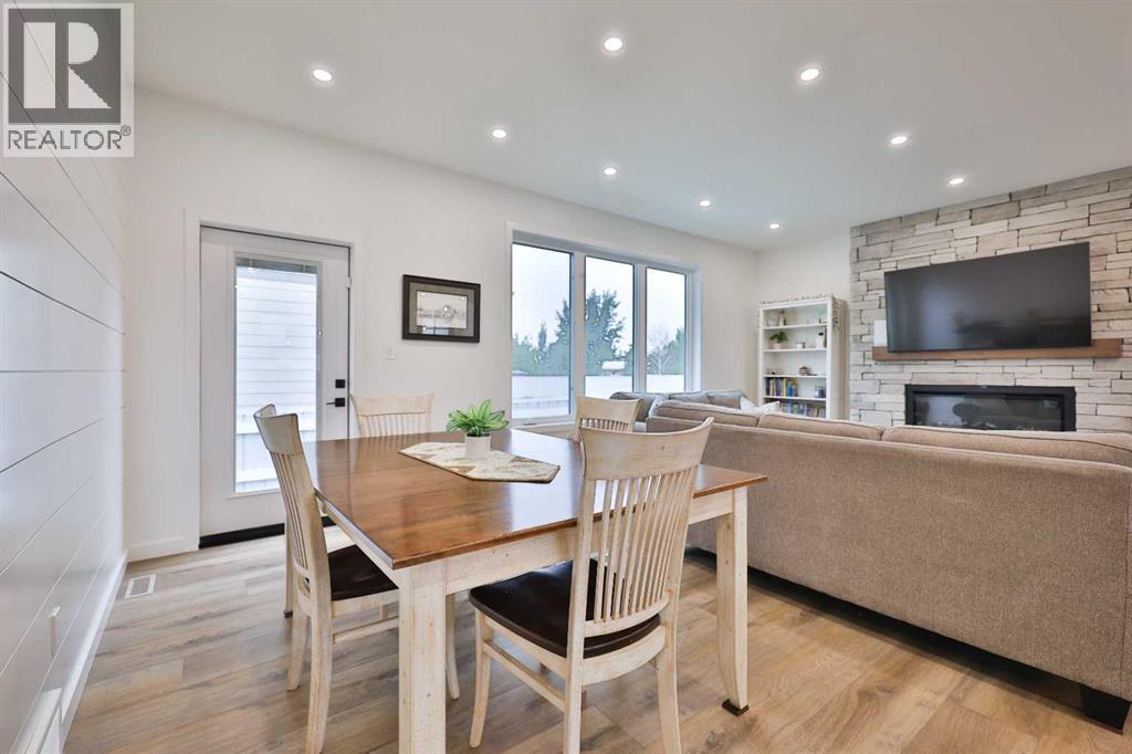 246 4A Street, Stirling, AB - Indoor Photo Showing Dining Room With Fireplace