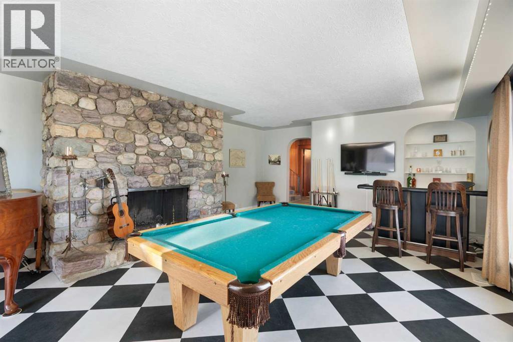 Parlor/Rec Room - 10507 Bradbury Drive Sw, Calgary, AB - Indoor Photo Showing Other Room With Fireplace