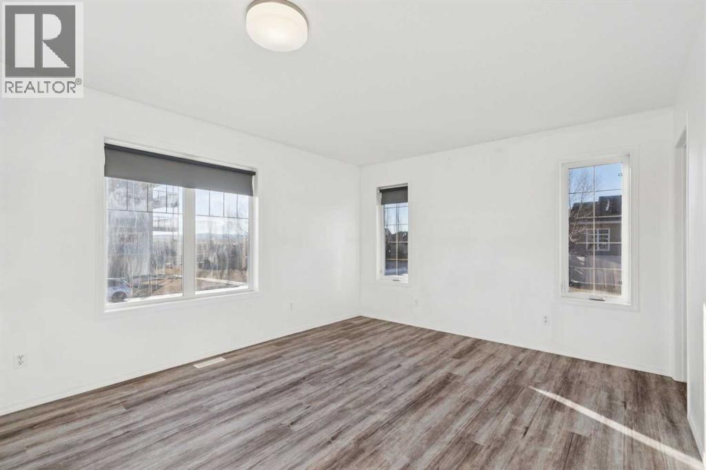 Primary Suite - Main Floor - 100B Westview Drive, Nanton, AB - Indoor Photo Showing Other Room