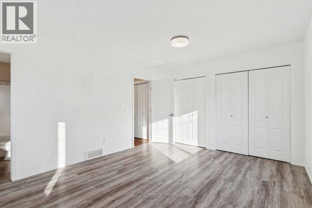 Primary Suite - Main Floor - 100B Westview Drive, Nanton, AB - Indoor Photo Showing Other Room