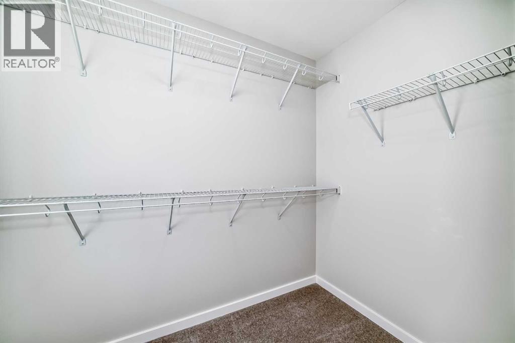 PLEASE NOTE: Photos are of a DIFFERENT Spec Home of the same model – fit and finish may differ. Interior selections and floorplans shown in photos - 158 Bartlett Crescent Se, Calgary, AB - Indoor With Storage